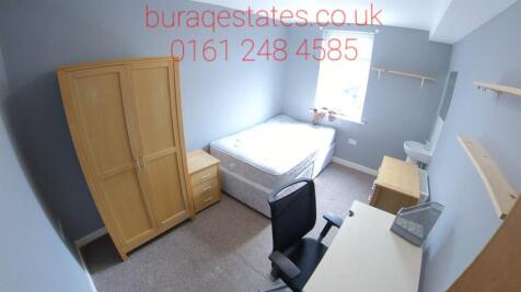 Bright, simply furnished bedroom with a comfort...