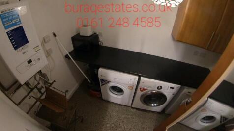 Compact utility-style kitchen area with integra...