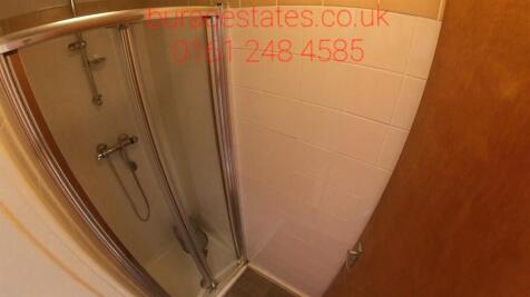 Compact bathroom with a framed glass shower cub...