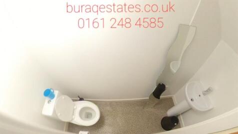 Compact WC with modern white toilet and wall-mo...