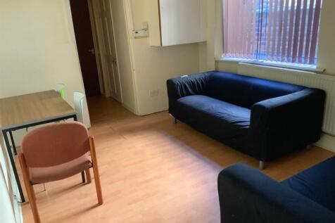 A bright, well-maintained living room featuring...