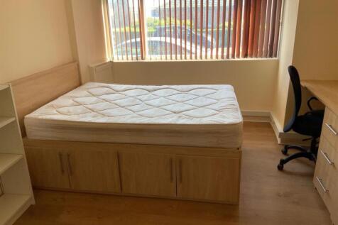 A spacious and bright master bedroom featuring ...