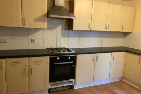 A functional kitchen with beige cabinets and a ...