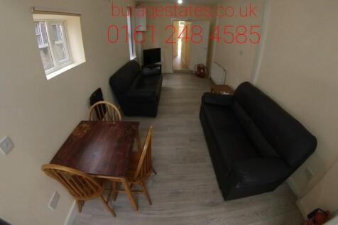 A well-maintained living room featuring a comfo...