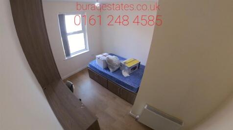 A cozy single bedroom featuring a comfortable b...