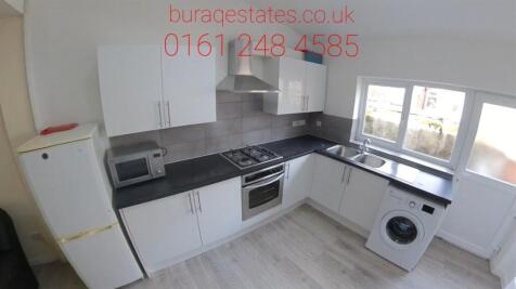 Bright modern fitted kitchen with white cabinet...