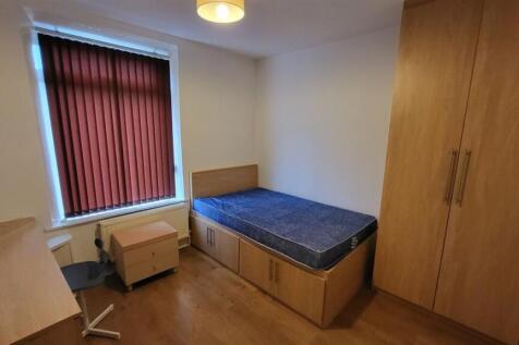 A bright, well-maintained bedroom featuring a s...