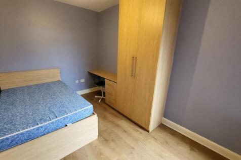 A well-maintained bedroom featuring a queen-siz...