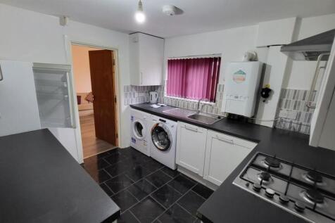 A well-maintained kitchen with ample natural li...