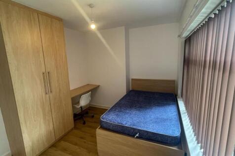 A bright and tidy single bedroom featuring a co...