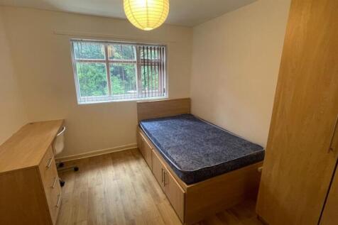 A neatly maintained single bedroom featuring a ...