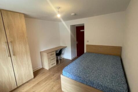 A cozy bedroom featuring a double bed, fitted w...