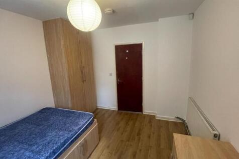 A clean and simple bedroom featuring a single b...