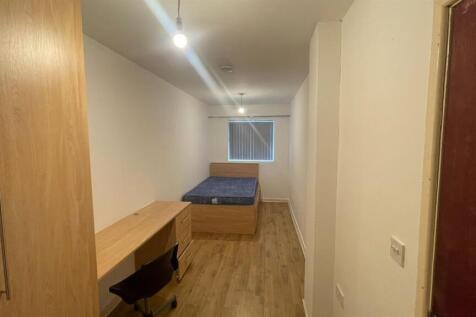 A compact but well-maintained bedroom with a si...