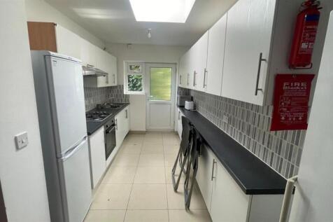 A modern, well-lit kitchen with clean surfaces ...