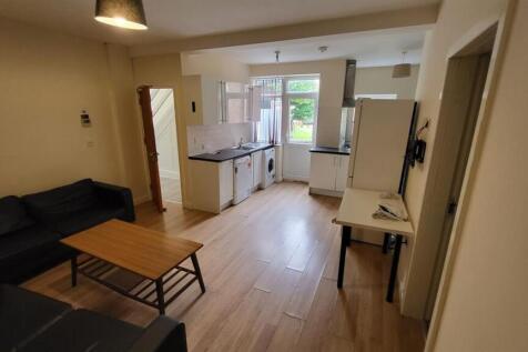 A spacious and well-lit living room with modern...