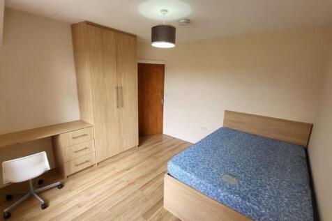 A well-maintained bedroom featuring a comfortab...