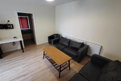 A spacious and well-lit contemporary living roo...