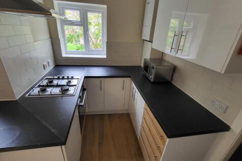 A bright, modern kitchen with ample counter spa...