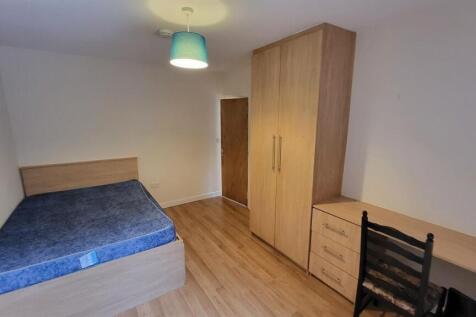 A tidy and well-maintained bedroom featuring a ...