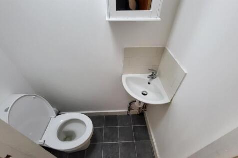 A clean and functional bathroom with a toilet a...