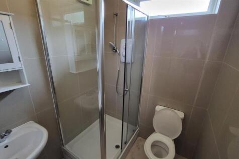A clean and modern bathroom featuring a shower ...