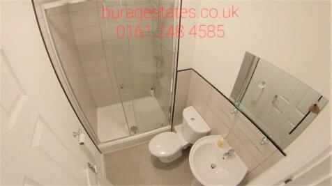 A compact and clean bathroom featuring a modern...