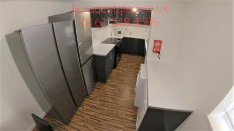 A modern kitchen with dark cabinets and wooden ...