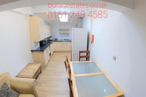 A bright and tidy kitchen and dining area featu...