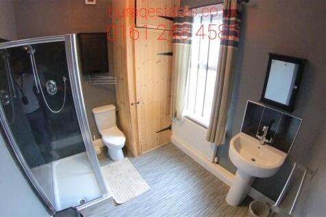 Bright and modern bathroom suite featuring a sp...