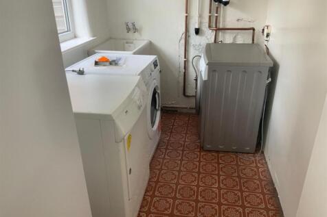 A functional bathroom equipped with laundry app...