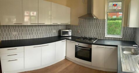 Modern fitted kitchen with white gloss units, i...