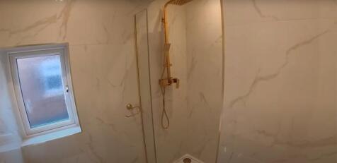 A spacious bathroom featuring a large bathtub a...