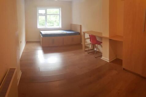 A bright and welcoming bedroom with a built-in ...