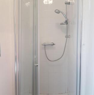 A clean and functional bathroom with a shower a...