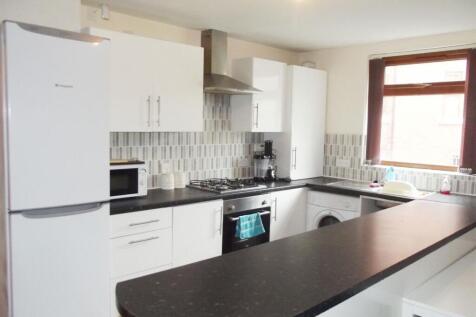 A bright and modern kitchen with ample natural ...