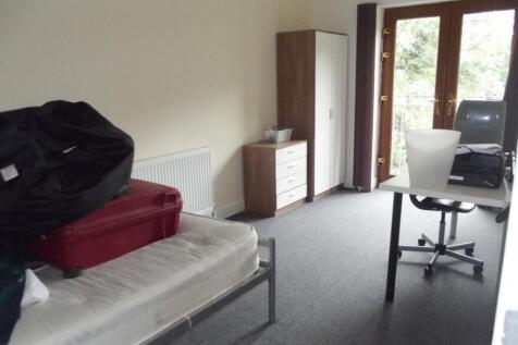 A spacious bedroom featuring a single bed frame...