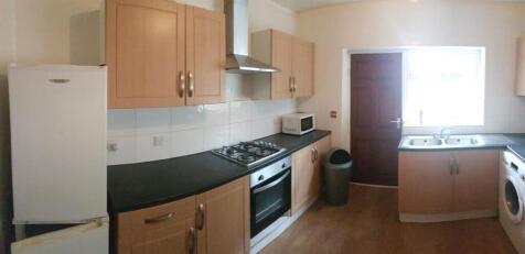 A bright and functional kitchen with ample cabi...