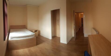 A spacious and well-maintained bedroom featurin...