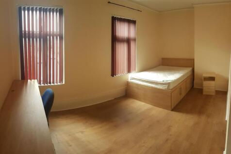 A clean and bright single bedroom featuring a c...