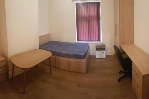 A compact, tidy private toilet area featuring a...