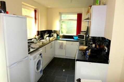 A bright and functional kitchen featuring white...