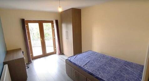 A well-maintained bedroom featuring a double be...