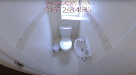 Bright and clean single toilet featuring modern...