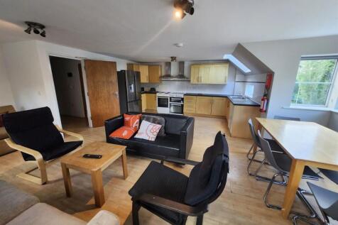 Bright open-plan living area with modern fitted...