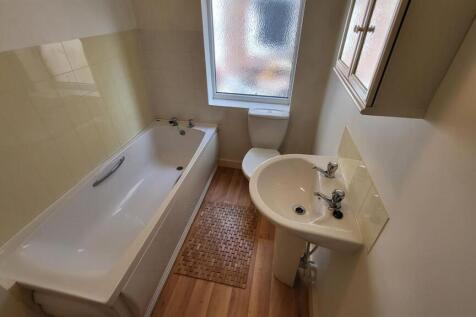A bright and clean bathroom featuring a spaciou...
