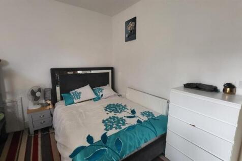 A cozy single bedroom featuring a comfortable b...