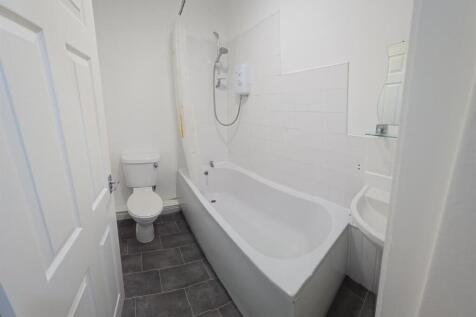 A clean and modern bathroom featuring a large b...