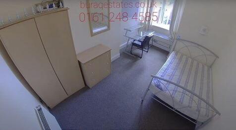 A compact and tidy single bedroom featuring a m...