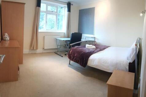 A tidy student bedroom featuring a single bed, ...